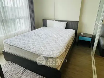 Cozy bedroom with modern decor and large window for natural light