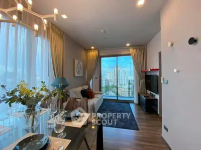 Modern living room with city view, elegant decor, and natural light