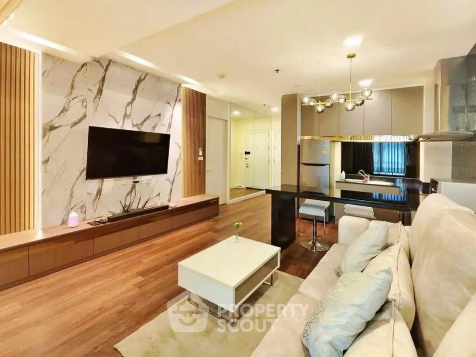 Luxurious modern living room with elegant decor and open kitchen layout, perfect for stylish urban living.