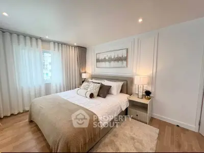 Luxurious bedroom with elegant decor and large window in modern apartment