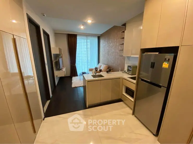 Modern kitchen with sleek cabinetry and integrated appliances in a stylish apartment.
