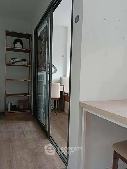 Modern apartment interior with sliding glass doors and wooden flooring