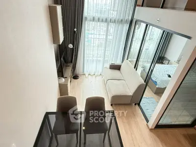Modern loft apartment with floor-to-ceiling windows and stylish interior design