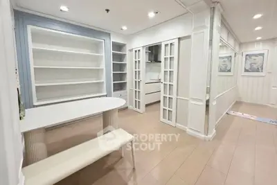 Elegant interior with built-in shelves and modern dining area in a stylish apartment.