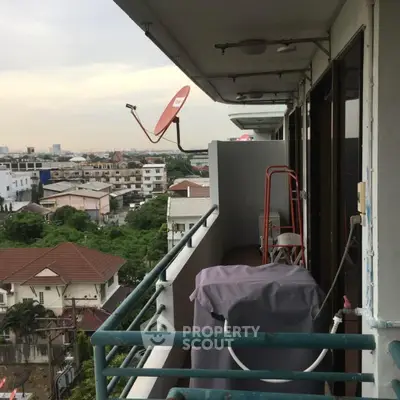 Charming balcony with city view and satellite dish, perfect for relaxation and enjoying the skyline.