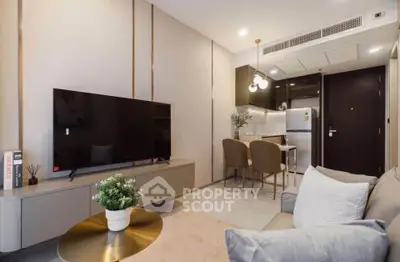 Modern living room with sleek furniture and open kitchen layout, perfect for urban living.
