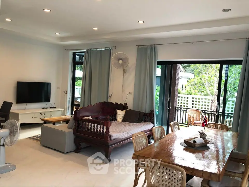 Spacious living room with elegant wooden furniture and garden view
