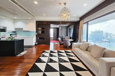 Luxurious open-plan living room with stunning city view and elegant chandelier