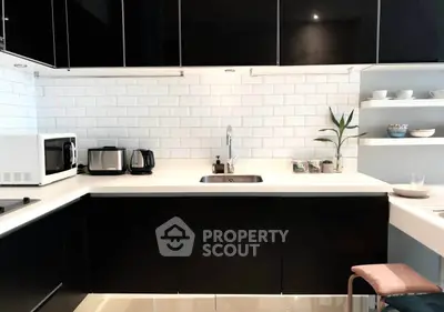 Modern kitchen with sleek black cabinets and white subway tile backsplash