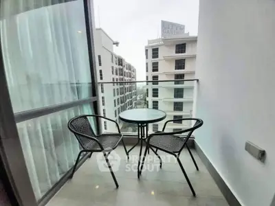 Modern balcony with glass railing and city view, perfect for relaxation.