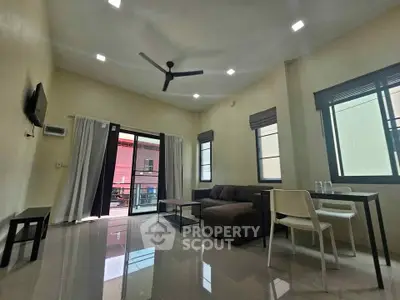 Spacious modern living room with sleek furniture and large windows for natural light.