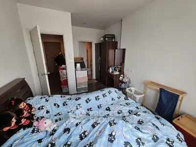 Cozy bedroom with playful bedding and ample storage space