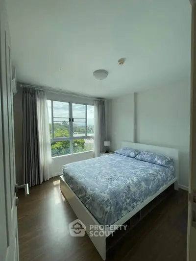 Bright and cozy bedroom with large window and stylish decor