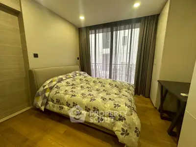 Cozy bedroom with modern decor and large window for natural light
