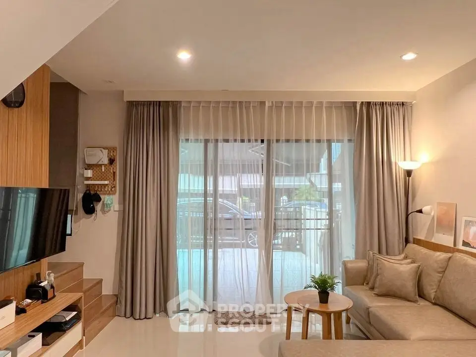 Modern living room with cozy sofa and large window for natural light