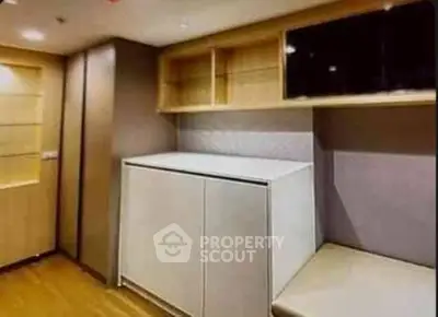 Modern storage space with sleek cabinetry and wooden flooring