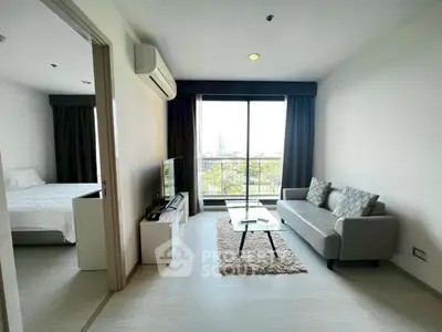 Modern living room with balcony view and cozy furniture in a stylish apartment.