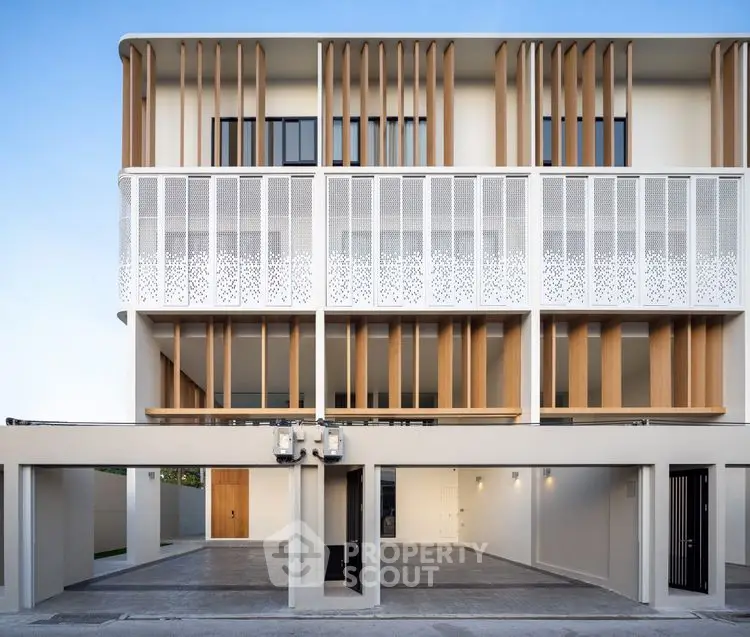 Modern architectural facade with sleek design and open parking area