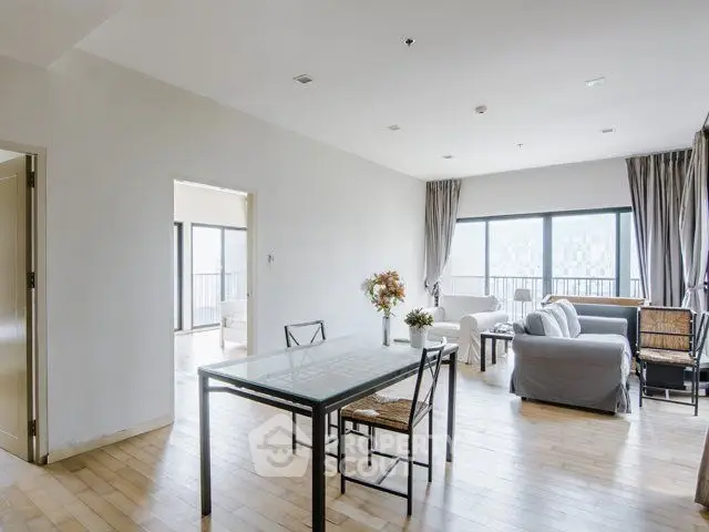 Spacious modern living room with large windows and elegant decor