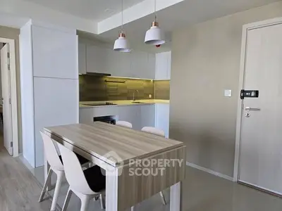 Modern kitchen with sleek dining table and stylish lighting fixtures