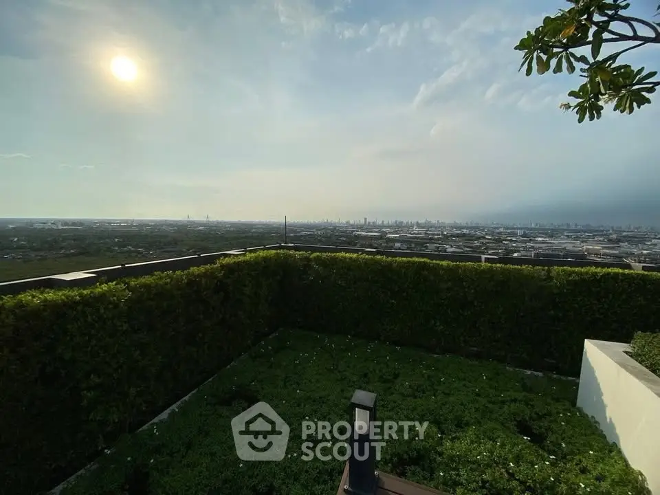 Stunning rooftop garden with panoramic city view at sunset, perfect for relaxation and entertainment.