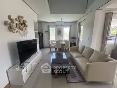 Modern living room with sleek furniture and natural light, perfect for relaxation and entertainment.