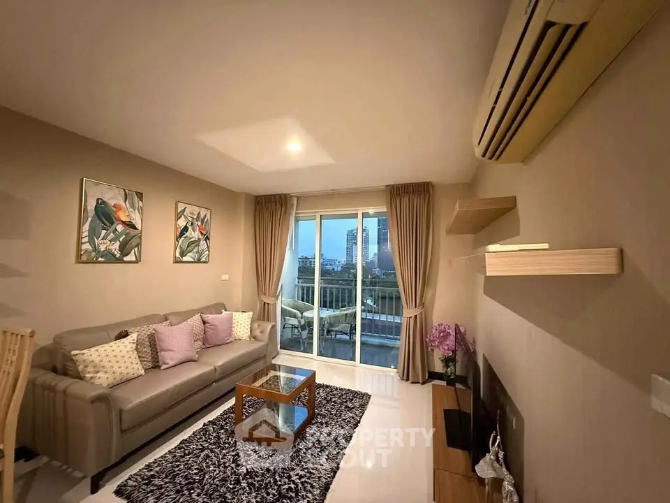 Stylish living room with modern decor and city view balcony in luxury apartment.
