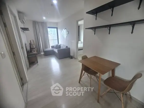 Modern apartment interior with cozy living room and dining area, featuring stylish furniture and natural light.