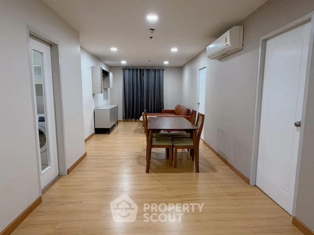 Spacious living room with modern furniture and wooden flooring