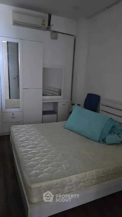 Cozy bedroom with modern furniture and air conditioning, perfect for comfortable living.