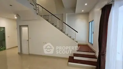 Spacious modern interior with elegant staircase and natural light