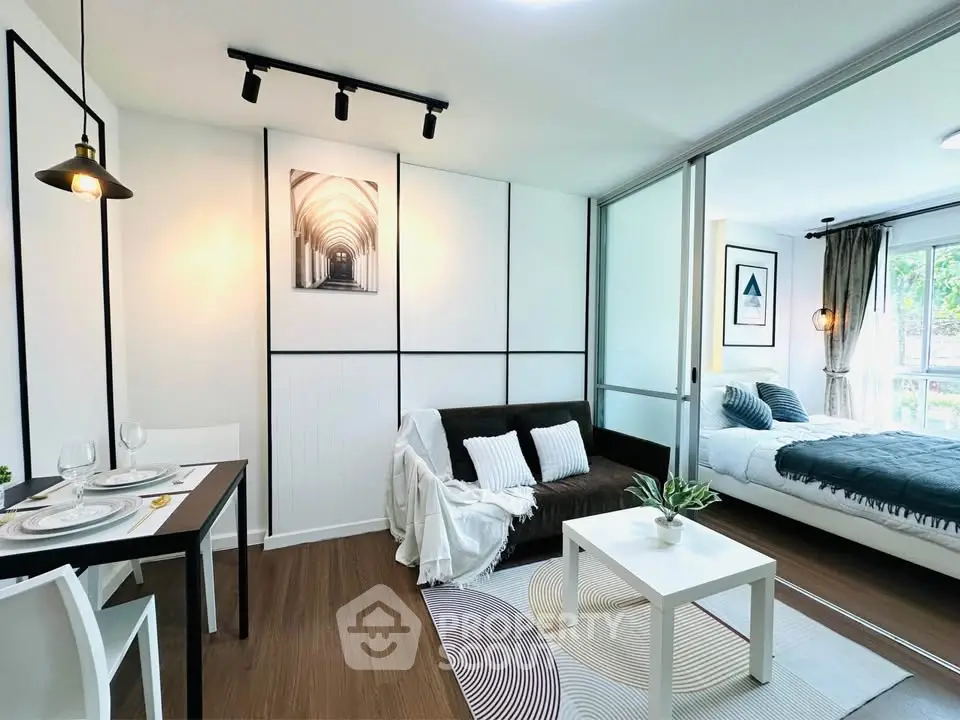 Modern open-plan living room with stylish decor and cozy bedroom