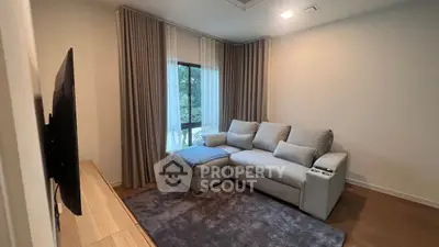 Cozy living room with modern sofa and large window view.