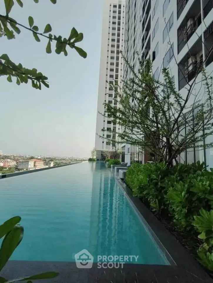 Luxurious high-rise building with stunning infinity pool and lush greenery