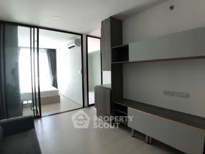 Modern apartment interior with sliding glass doors and built-in storage