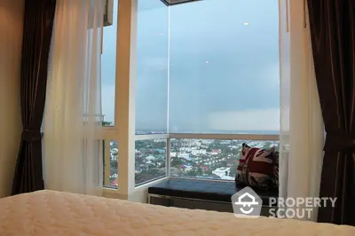 Luxurious bedroom with panoramic city view from large windows