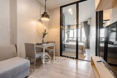 Modern apartment interior with open living and dining area, featuring sleek design and natural light.