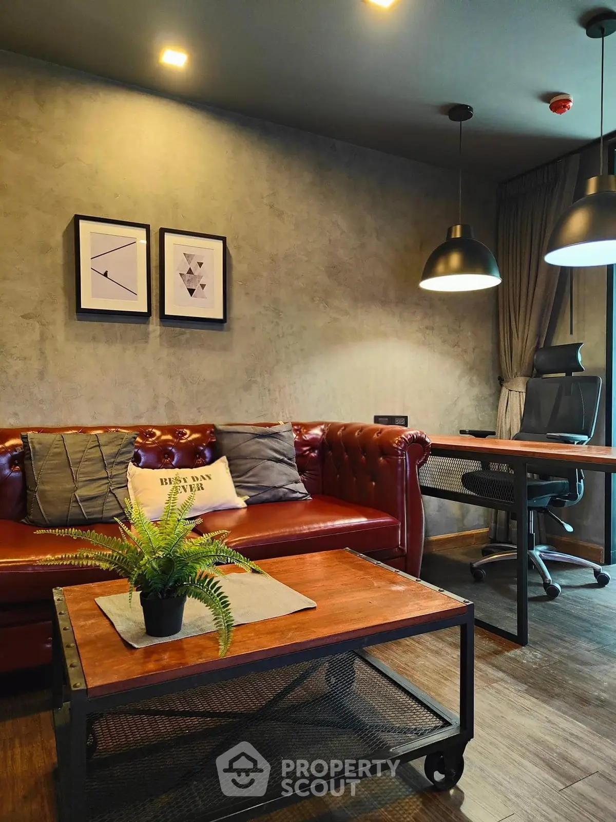 Stylish modern living room with leather sofa and sleek office desk, perfect for work and relaxation.