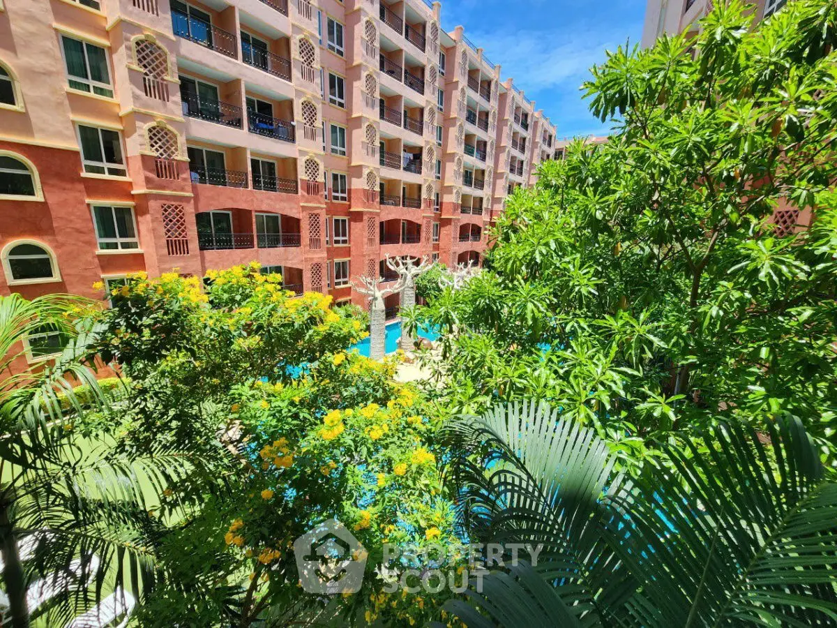 Lush garden view from a vibrant residential complex with pool