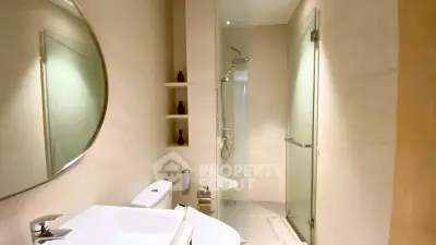 Modern bathroom with sleek shower and elegant fixtures in luxury apartment.