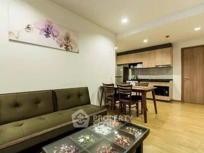 Modern open-plan living room with stylish kitchen and cozy seating area.