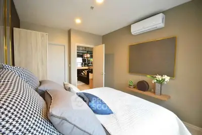Modern bedroom with stylish decor and air conditioning in a cozy apartment.