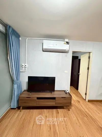 Modern living room with sleek TV stand and air conditioning unit