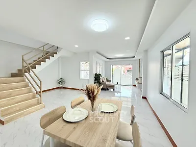 Spacious open-plan living and dining area with modern decor and natural light.