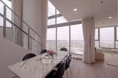 Luxurious high-rise apartment with stunning city view and elegant dining area.