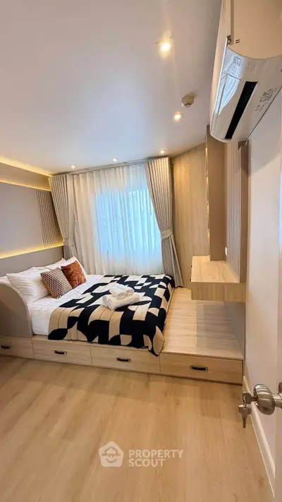 Modern bedroom with stylish decor and built-in storage, featuring a cozy bed and elegant lighting.