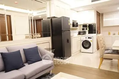 Modern open-layout kitchen with sleek appliances and cozy living area