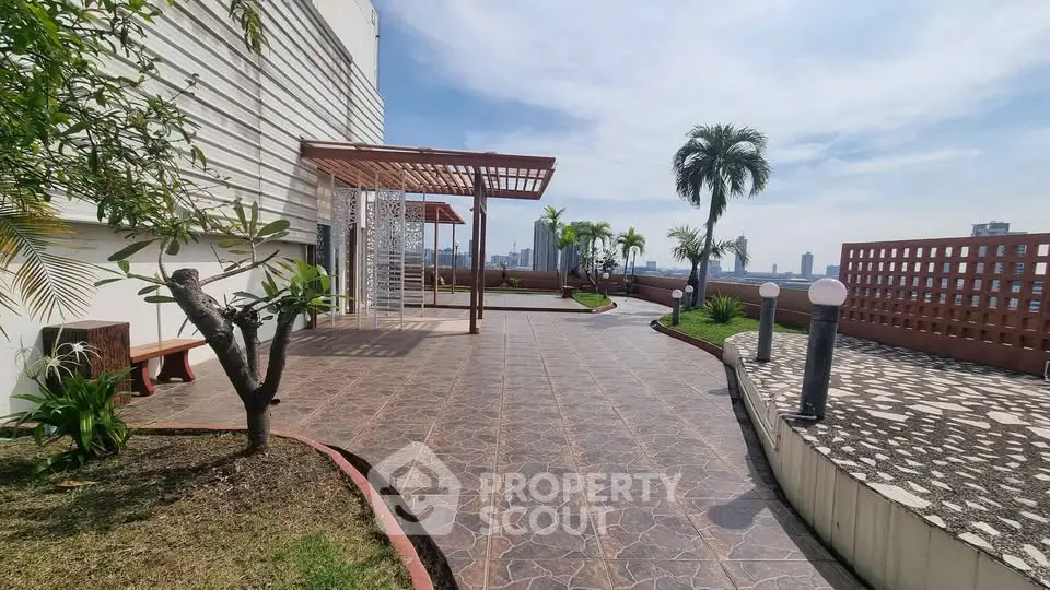 Stunning rooftop terrace with city views and lush greenery, perfect for relaxation and entertainment.