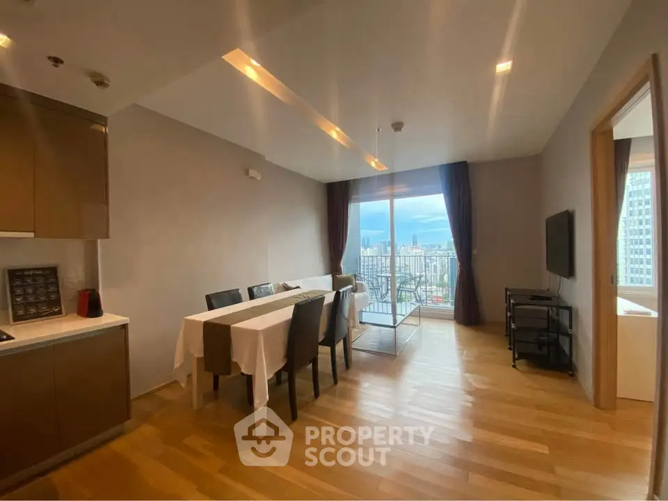 Modern dining area with city view in high-rise apartment