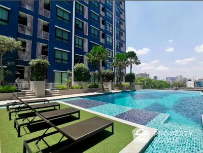 Luxurious apartment complex with stunning pool and city view, perfect for relaxation and leisure.